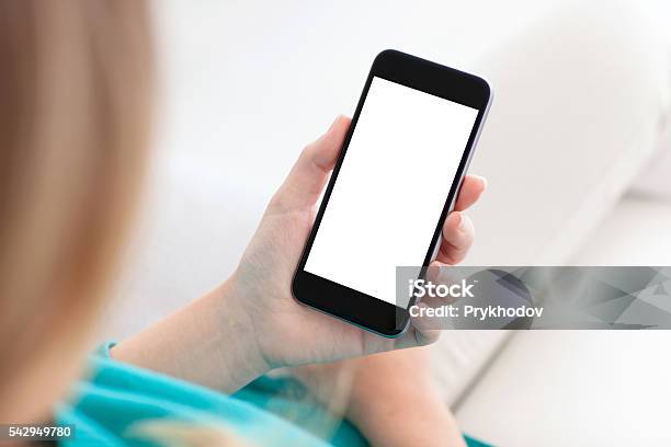 Woman Holding A Phone With Isolated Screen On A Sofa Stock Photo - Download Image Now