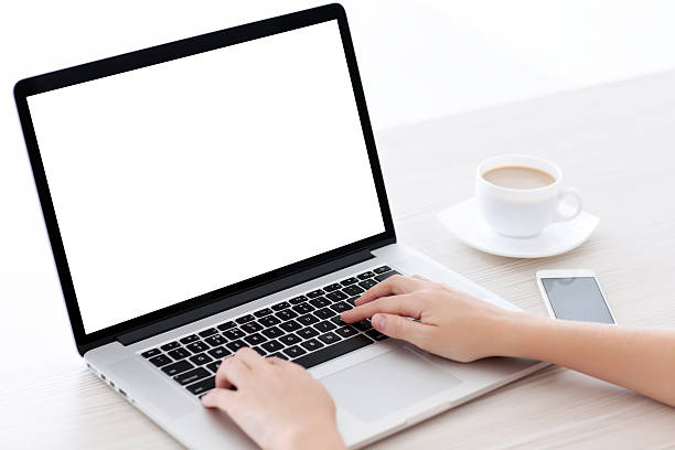istock Female hands typing on a laptop keyboard with isolated screen 542950080