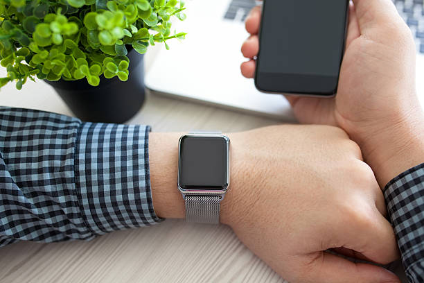 Man hands with watch and phone with a laptop