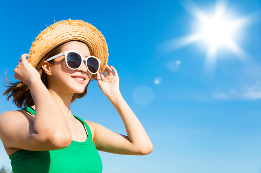 Young  woman relaxing and watching sunlight at summer