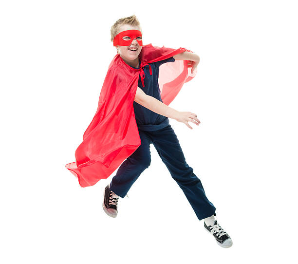 istock Cheerful little superhero jumping 542952076