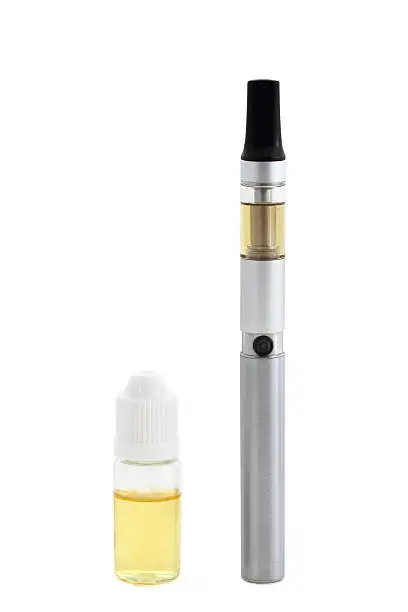 Small e-cigarette with liquid bottle isolated on white background