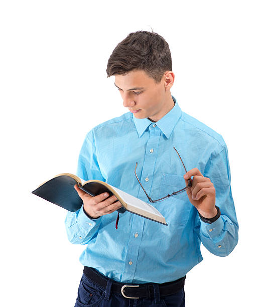 istock Teenager read and study from black book with eyeglasses isolated 542953088