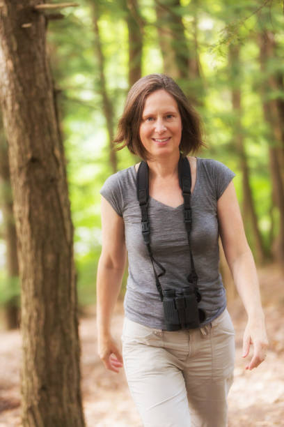 istock Mature Woman Bird Watching with Binoculars 542953562