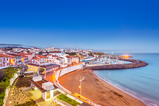 The beach and harbor of the Uneseco world heritage town of Angra de Heroismo on Terceira Island at dusk.