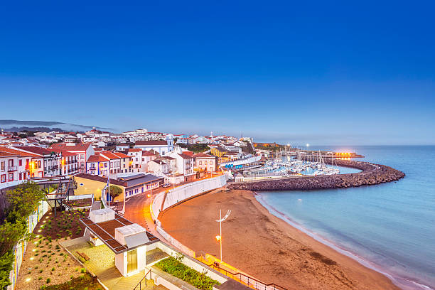 Angra do Heroismo waterfront at dusk, Terceira (Azores) The beach and harbor of the Uneseco world heritage town of Angra de Heroismo on Terceira Island at dusk. terceira azores stock pictures, royalty-free photos & images