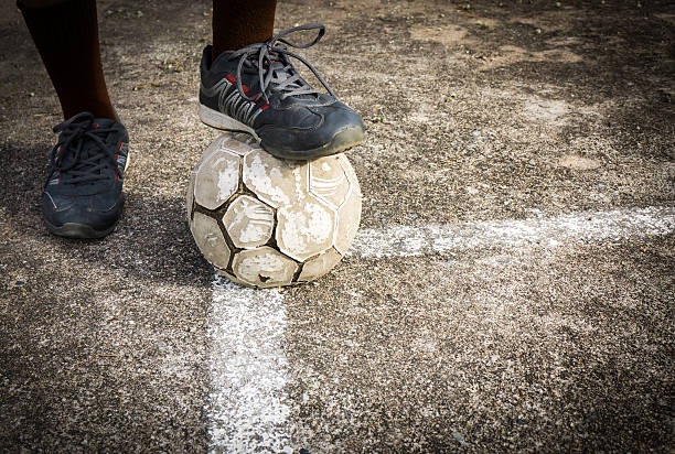 istock Playing old football on concrete field 542956466