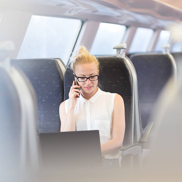 istock Business woman working while travelling by train. 542957028