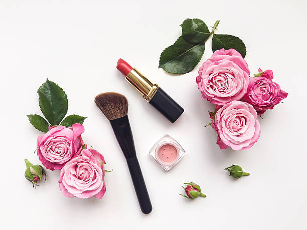 Decorative flat lay composition with cosmetics and flowers. Top view Decorative flat lay composition with cosmetics and flowers. Flat lay, top view on white background make up brush photos stock pictures, royalty-free photos & images