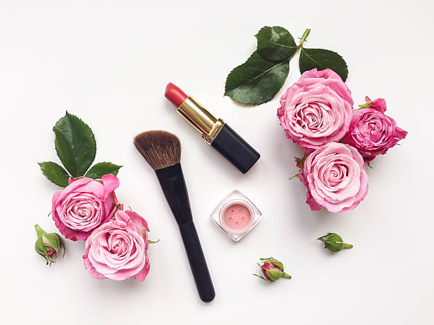 Decorative flat lay composition with cosmetics and flowers. Top view Decorative flat lay composition with cosmetics and flowers. Flat lay, top view on white background female accessory stock pictures, royalty-free photos & images