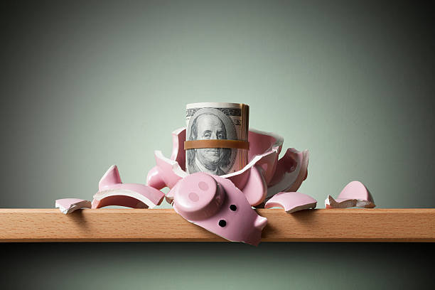 istock Savings. Broken piggy bank with dollars banknotes 542960694