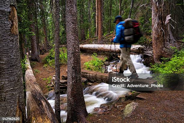 Hiker Crosses Bridge Over Mountain Creek Stock Photo - Download Image Now - Vail - Colorado, Hiking, Colorado