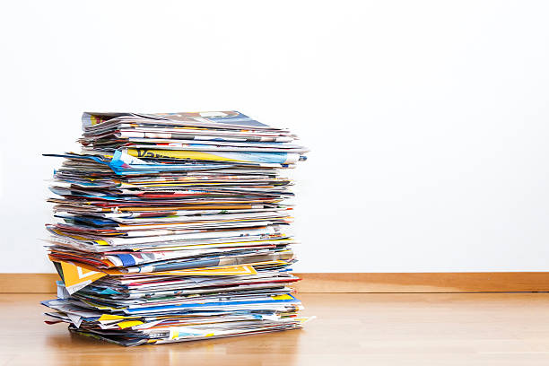 Tall pile of newspaper advertisements stock photo
