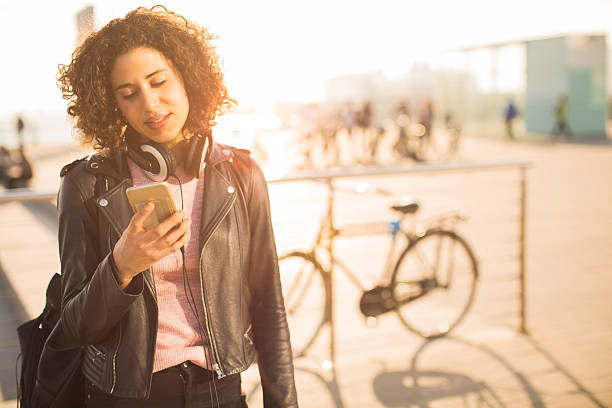 istock Beautiful young woman texting on her smart phone. 542964482