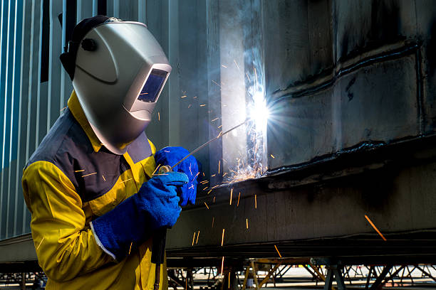 istock Industry worker with welding steel to repair container 542966338