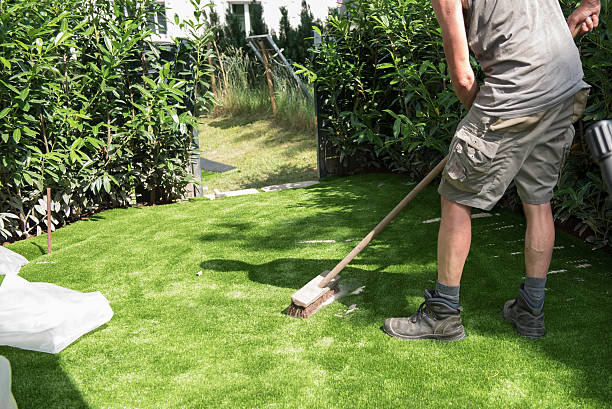 istock professional gardener puts sand on artificial turf 542966690