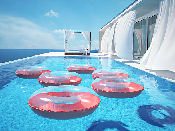 istock luxury swimming pool with swimmrings. 3d rendering 542968722