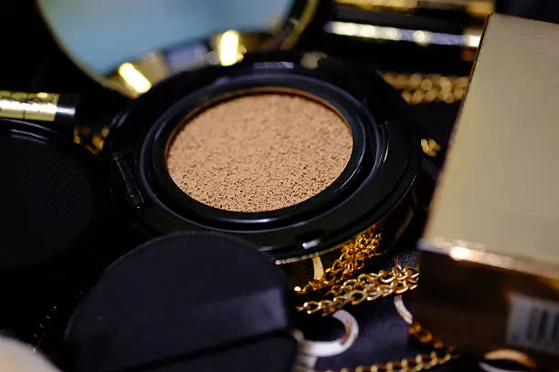 Photo of cosmetics gold set for background.  (Selective focus)