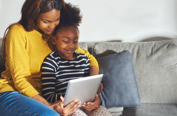 istock Black mom and child with tablet 542970576