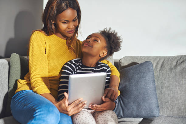 istock Black mom and daughter with tablet 542970704