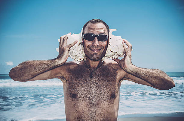 istock Funny Sea DJ  - Man with shells on his ears 542971628