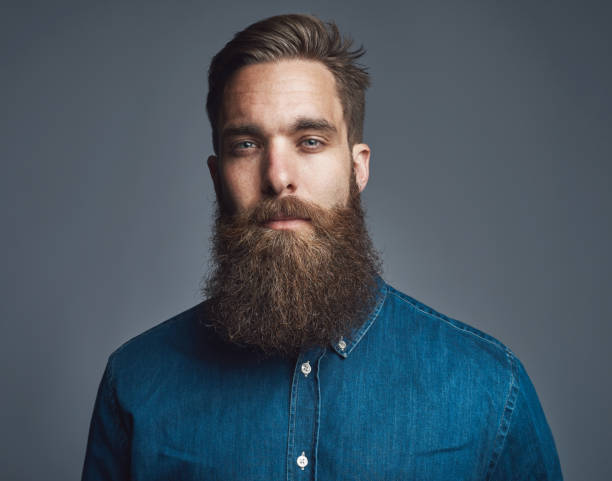 istock Bearded man in blue denim with tired expression 542972978