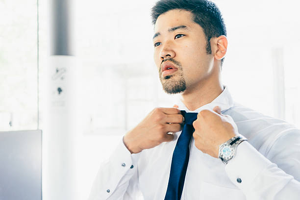 istock Young Businessman Tying His Tie 542973280