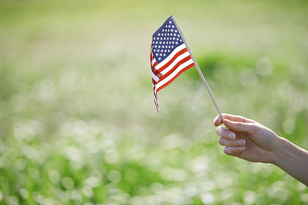 istock Woman holding US flag 542974036