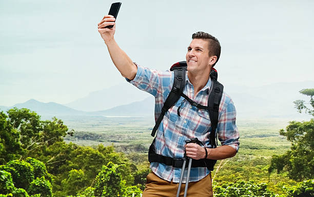istock Smiling hiker taking a selfie in mountain 542974196
