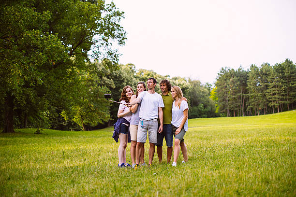 istock Group of friends spending weekend in nature and take selfie 543041918