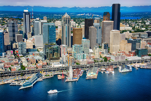 The beautiful downtown area of Seattle Washington with it's iconic waterfront in the foreground and the skyline of Bellevue in the distance.  I shot this image from an altitude of about 600 feet over the Puget Sound during a helicopter photo flight.  