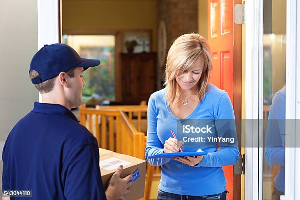 Residential Home Delivery Man Delivering Package To Customer Hz Stock Photo - Download Image Now