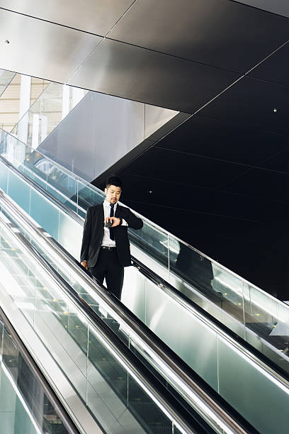 istock Businessman Checking The Time On Escalators 543044252