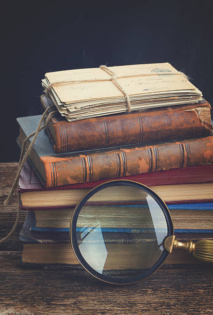istock pile of books with looking glass 543044302
