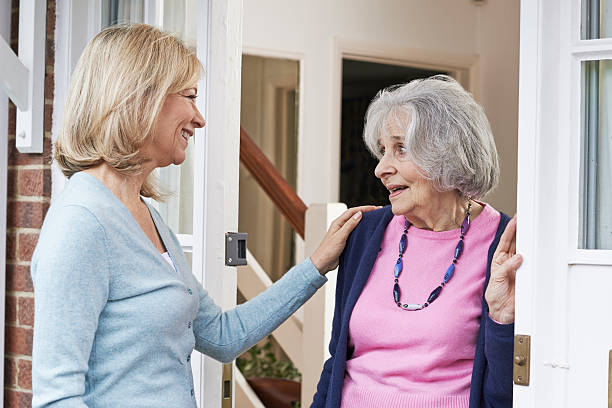 istock Woman Checking On Elderly Female Neighbor 543045266