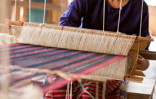 Thai traditional Weaving work and equipment with woven yarn in the background