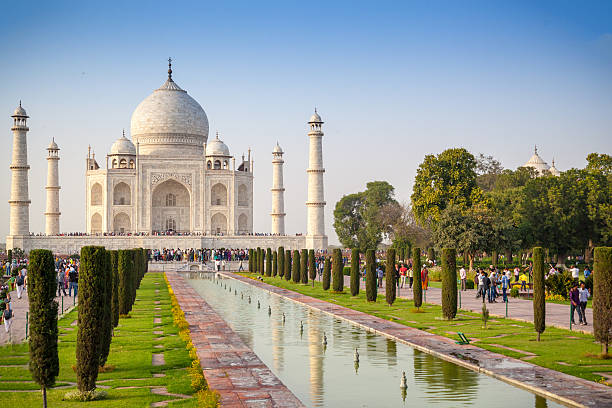 Taj Mahal The magnificent Taj Mahal, situated in the city of Agra, and its flow of tourists on a sunny Spring day. agra stock pictures, royalty-free photos & images