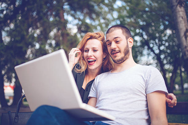 istock Lovers working with laptop outdoors 543050508