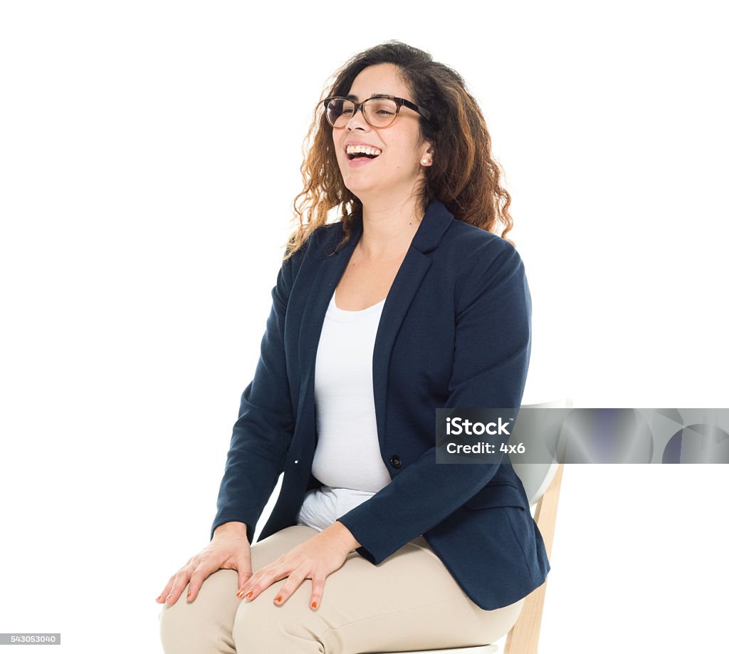 Cheerful businesswoman sitting on chair Cheerful businesswoman sitting on chairhttp://www.twodozendesign.info/i/1.png Sitting Stock Photo