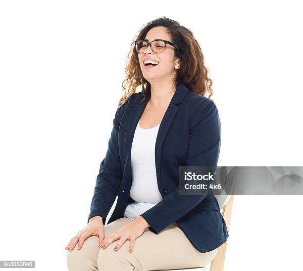 Cheerful Businesswoman Sitting On Chair Stock Photo - Download Image Now - Sitting, White Background, One Person