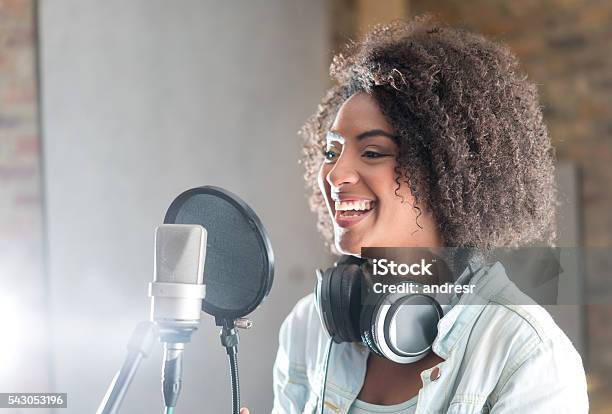 Happy Woman At A Recording Studio Stock Photo - Download Image Now - Singer, Recording Studio, Microphone