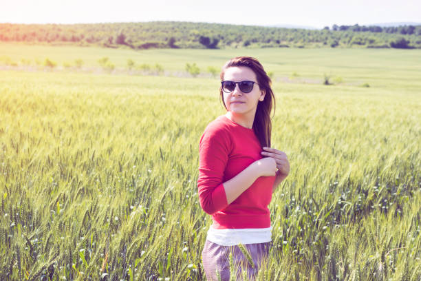 Portrait of a young girl on a background of ripe wheat field