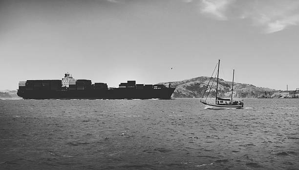 istock Container Ship and small boat in black and white 543055224