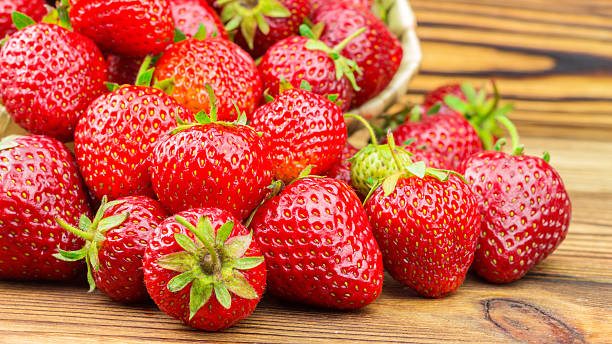 istock Full basket of strawberries that are poured out on table 543056894