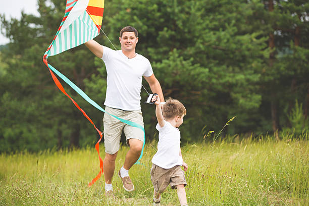 istock Father playing with son in park 543057240