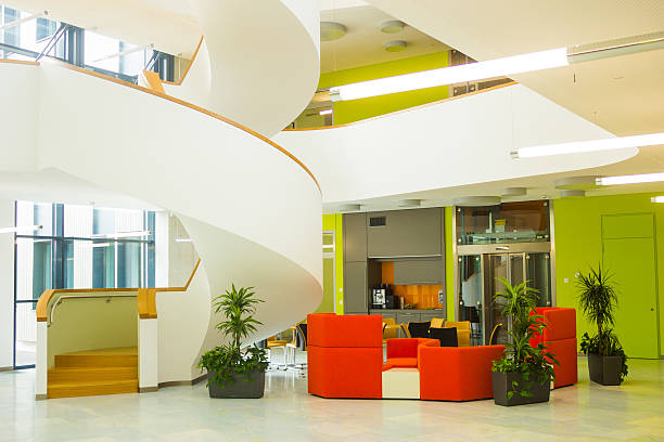 istock Cozy modern style cafe with red sofas near spiral stairs 543057324