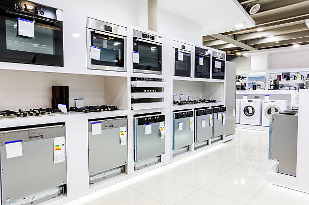 Home appliance in the store Gas and electric ovens and other home related appliance or equipment in the retail store showroom electronics store stock pictures, royalty-free photos & images