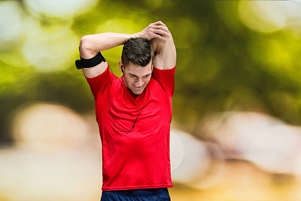 istock Smiling male runner stretching outdoors 543058154