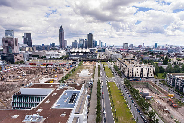 Panorama aerial view construction site of new exhibition hall 12, Frankfurt Messe, Europa-Allee and skyline of downtown Frankfurt