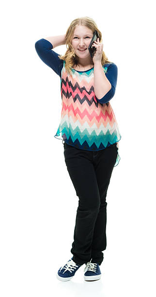 istock Smiling little girl talking on phone 543059180